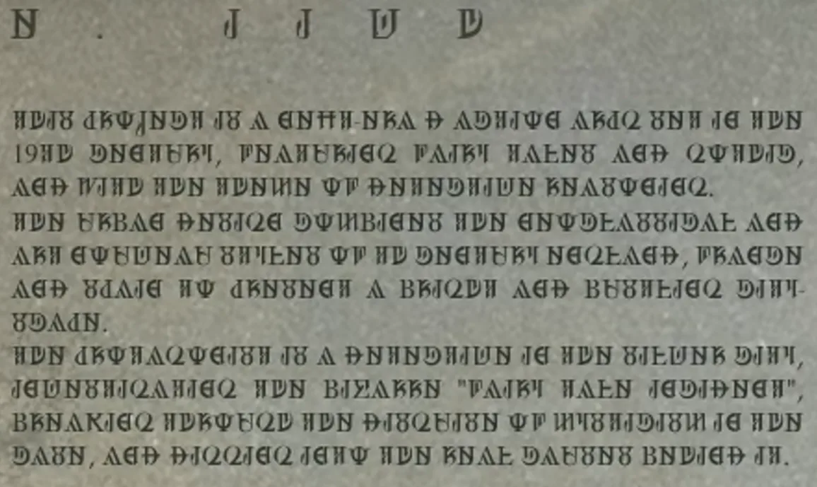 A stone wall panel from the Silver Palace Gameplay Showcase carrying four paragraphs of Silvernia script, the project description that decodes to English